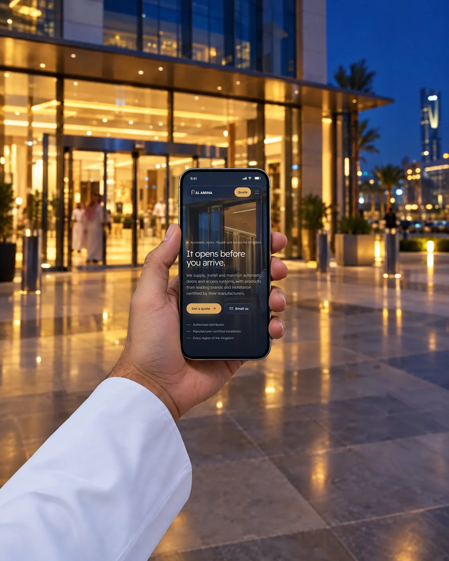 The English home page on a phone in front of an automatic door entrance