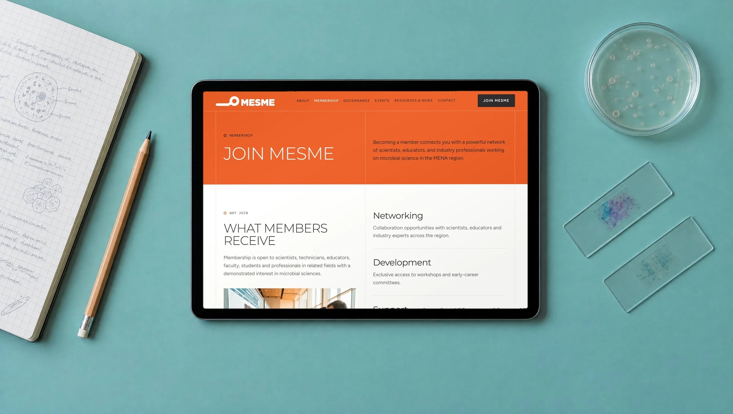 The MEsME membership page on a tablet beside a lab notebook